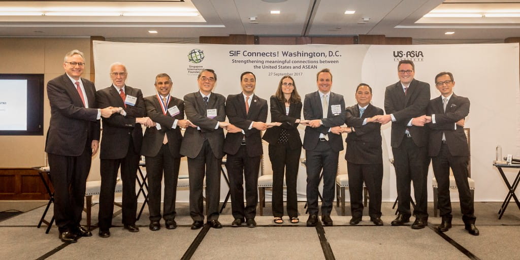 Dialogue panellists posing for the signature ASEAN handshake with Congressman Joaquin Castro, ambassadors from ASEAN countries and USAI representatives.