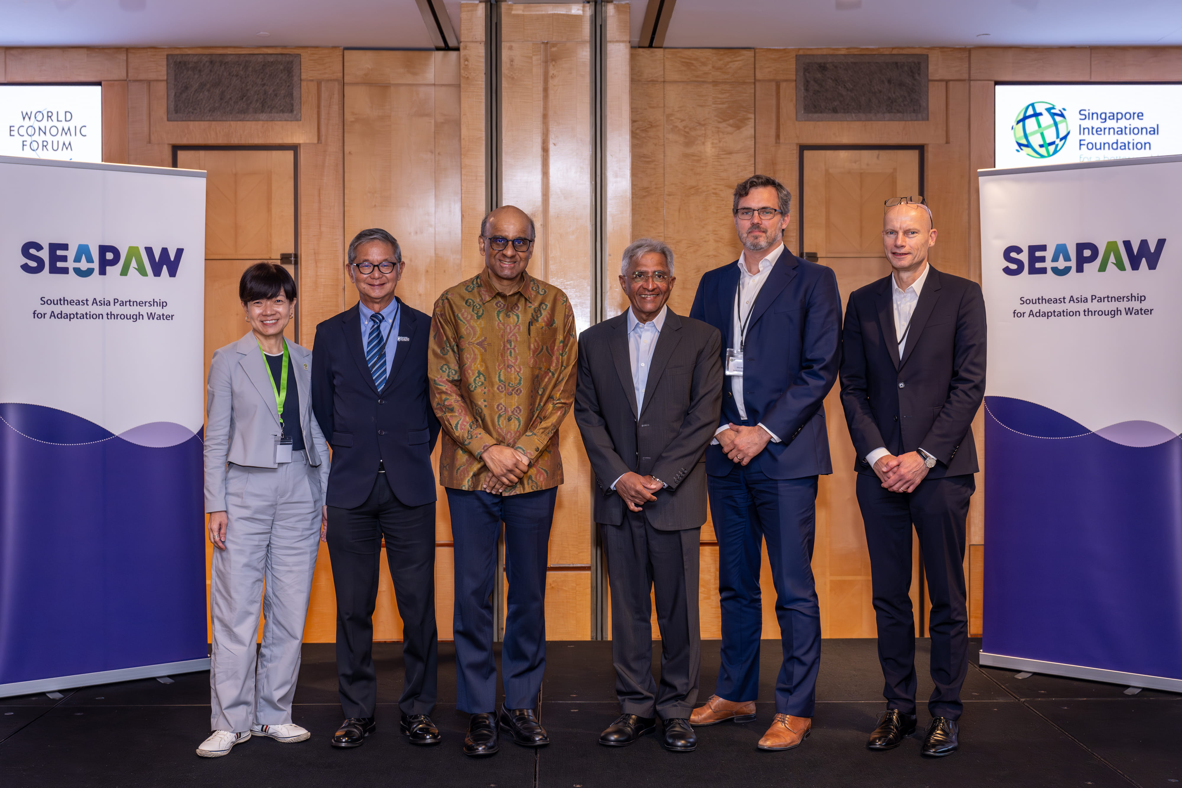 Representatives from partner organisations on stage with President of Singapore